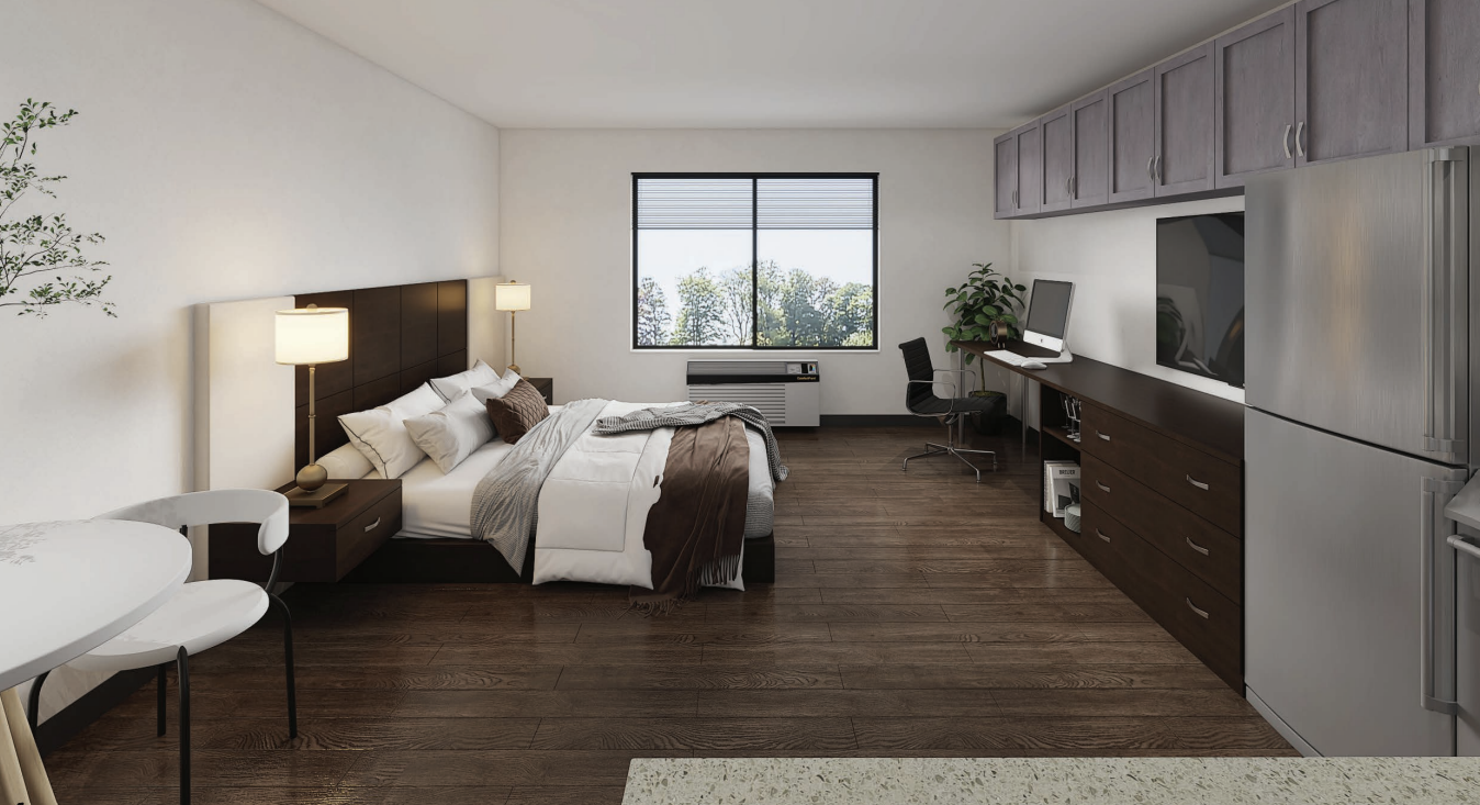 A bedroom with a bed, desk, and chair.